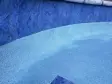 Waterline tile and speckled pebble pool finish seen close up under clear water