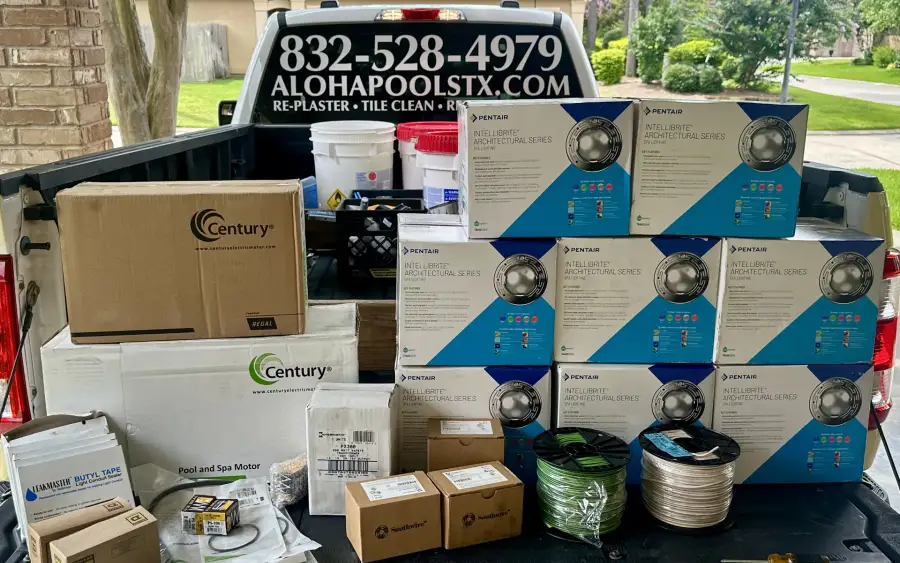 Boxes of new Pentair LED pool lights loaded in the bed of an Aloha service truck